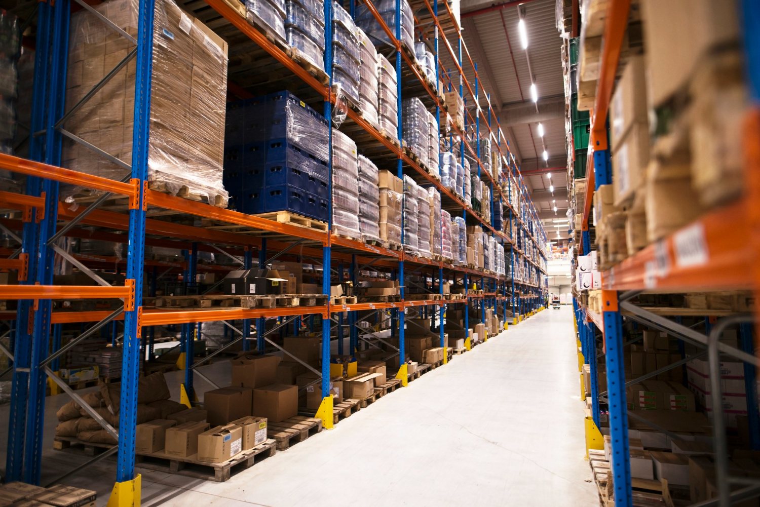 Pharmaceutical distribution warehouse aisle with palletized inventory