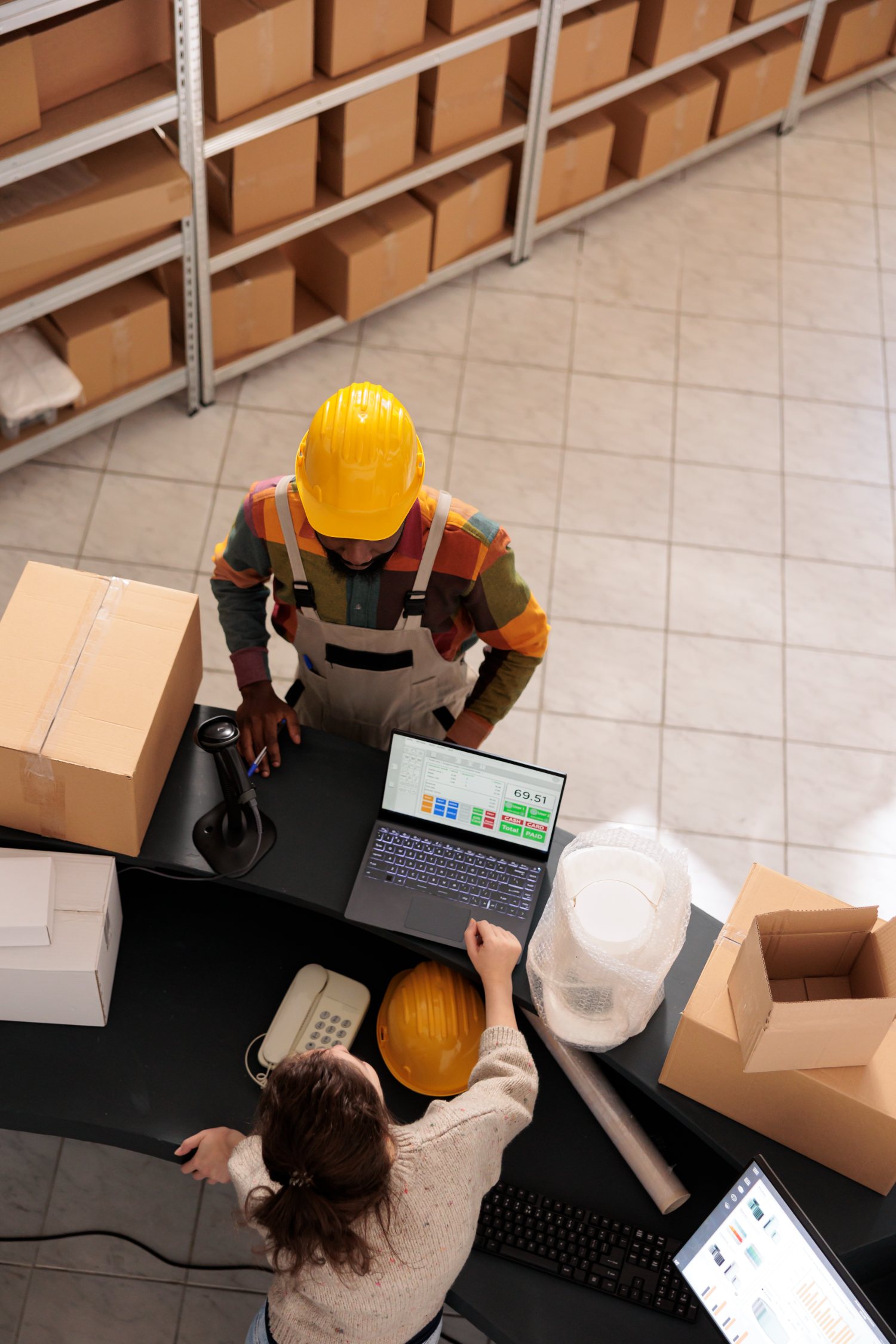 Fulfillment team packing and labeling prescription orders at a shipping station