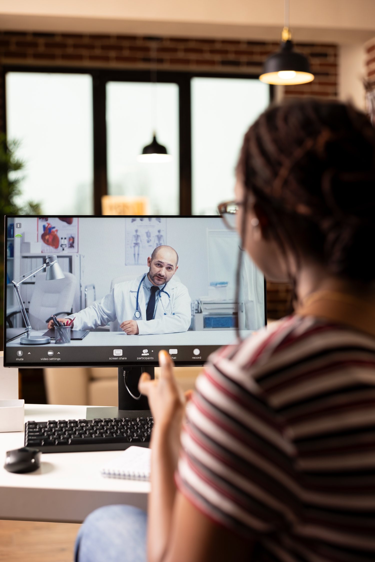 Patient in a telemedicine video consultation with a prescriber